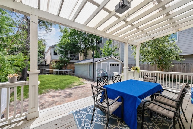 2408 Beall St, Houston, TX 77008 - wooden terrace featuring outdoor dining space, a fenced backyard, a storage shed, and a trampoline