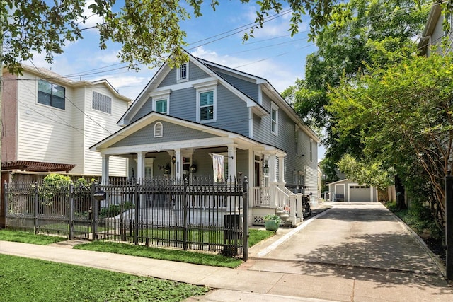 2408 Beall St, Houston, TX 77008 - view of front of house featuring covered porch, an outbuilding, a fenced front yard, and a detached garage