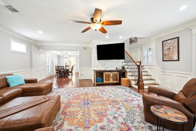 2408 Beall St, Houston, TX 77008 - living room featuring a decorative wall, ornamental molding, a ceiling fan, stairs, and a wainscoted wall