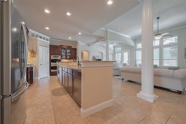 28210 Green Forest Bluff Trl, Katy, TX 77494 - kitchen with stainless steel appliances, decorative columns, ornamental molding, a ceiling fan, and open floor plan