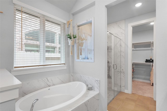 5122 Walnut Grove Ln, Manvel, TX 77578 - bathroom featuring a bath, a marble finish shower, a spacious closet, and lofted ceiling