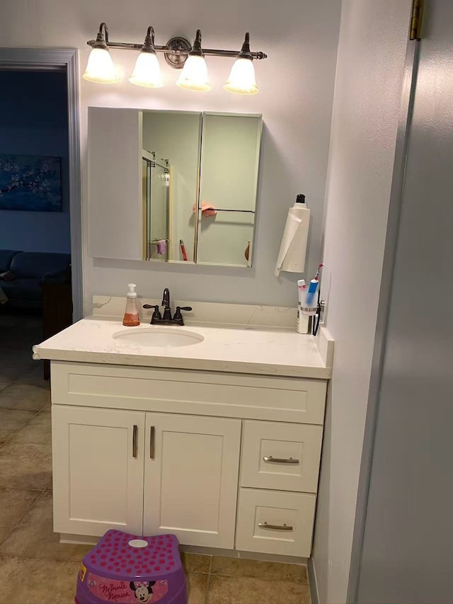1006 Lawndale Ave, Brenham, TX 77833 - full bathroom with vanity, tile patterned flooring, and an enclosed shower