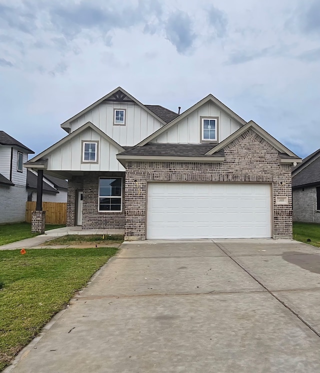 134 Peachleaf Ct, Anahuac, TX 77514 - view of front of property featuring board and batten siding, driveway, and brick siding