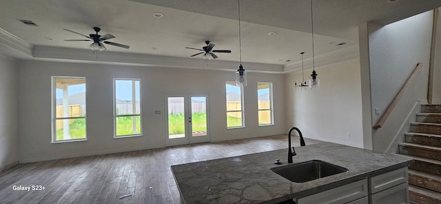 134 Peachleaf Ct, Anahuac, TX 77514 - kitchen featuring open floor plan, a raised ceiling, and crown molding