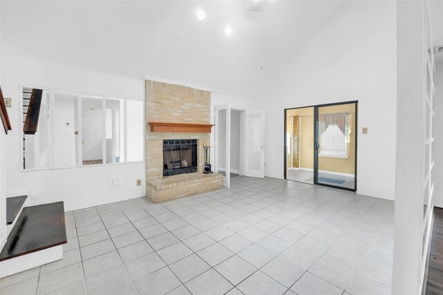 6803 Lakemont Dr, Houston, TX 77050 - unfurnished living room featuring a high ceiling, a fireplace, tile patterned flooring, and plenty of natural light