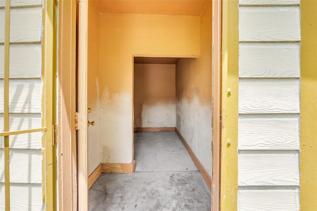 6803 Lakemont Dr, Houston, TX 77050 - hall featuring unfinished concrete floors and baseboards