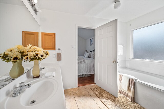 13814 Fort Nelson Dr, Houston, TX 77083 - full bathroom with a bath, double vanity, connected bathroom, and tile patterned flooring