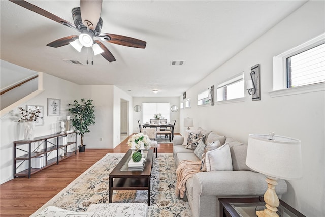 13814 Fort Nelson Dr, Houston, TX 77083 - living area featuring wood finished floors, ceiling fan, and baseboards