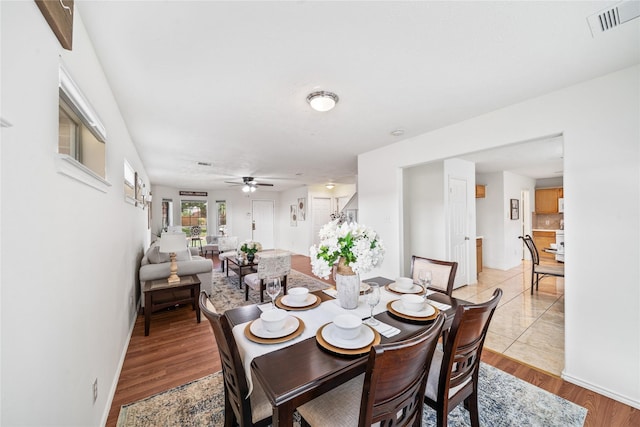 13814 Fort Nelson Dr, Houston, TX 77083 - dining space with ceiling fan, light wood-style flooring, and baseboards