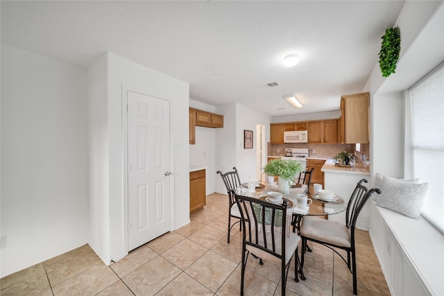 13814 Fort Nelson Dr, Houston, TX 77083 - dining room featuring light tile patterned flooring