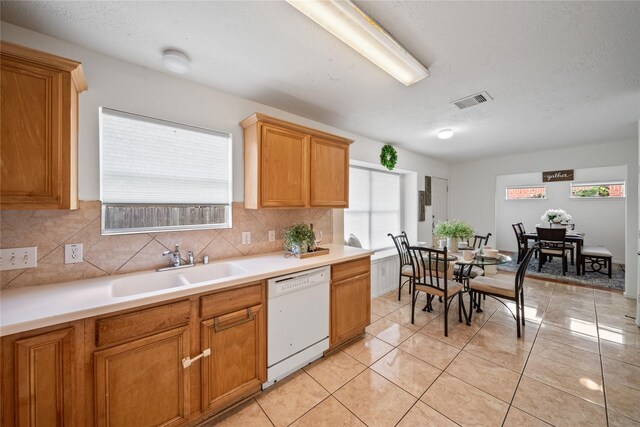 13814 Fort Nelson Dr, Houston, TX 77083 - kitchen featuring white dishwasher, a sink, decorative backsplash, and plenty of natural light