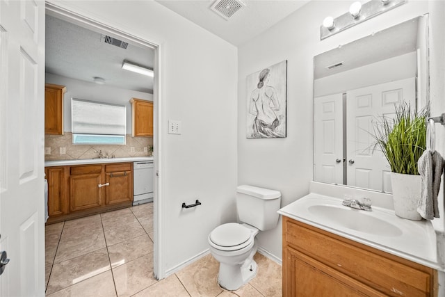 13814 Fort Nelson Dr, Houston, TX 77083 - bathroom featuring vanity, backsplash, tile patterned flooring, and toilet