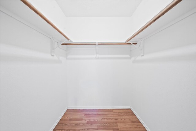 13814 Fort Nelson Dr, Houston, TX 77083 - walk in closet featuring light wood-style floors