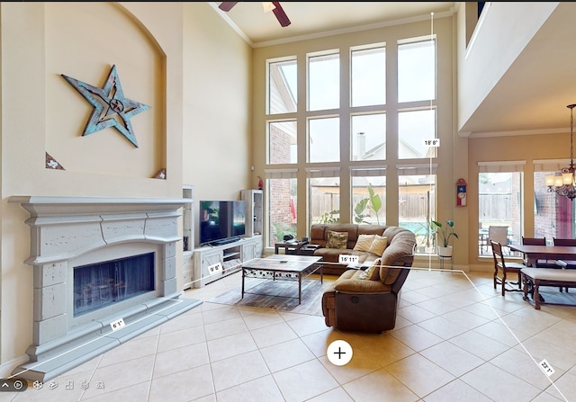 2402 Chesley Park Ct, Katy, TX 77494 - living area with ornamental molding, a chandelier, a towering ceiling, tile patterned flooring, and ceiling fan