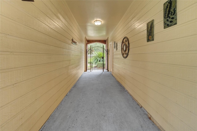 8034 High Hollow Ln, Houston, TX 77070 - hall featuring wood walls and unfinished concrete floors