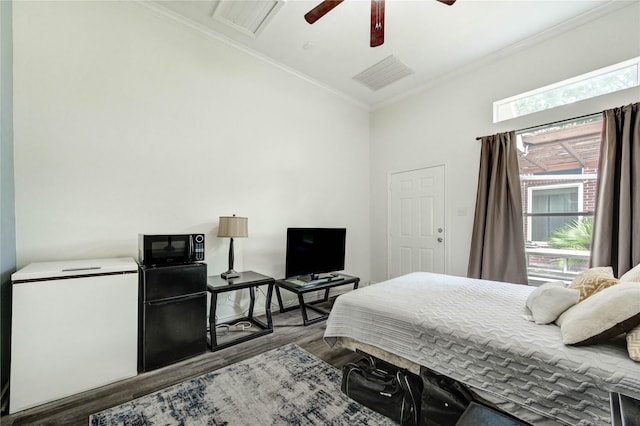 8034 High Hollow Ln, Houston, TX 77070 - bedroom with white refrigerator, wood finished floors, ornamental molding, refrigerator, and a ceiling fan