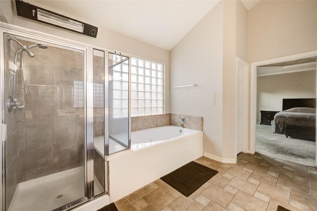 8034 High Hollow Ln, Houston, TX 77070 - ensuite bathroom featuring a garden tub, a stall shower, lofted ceiling, and stone finish flooring
