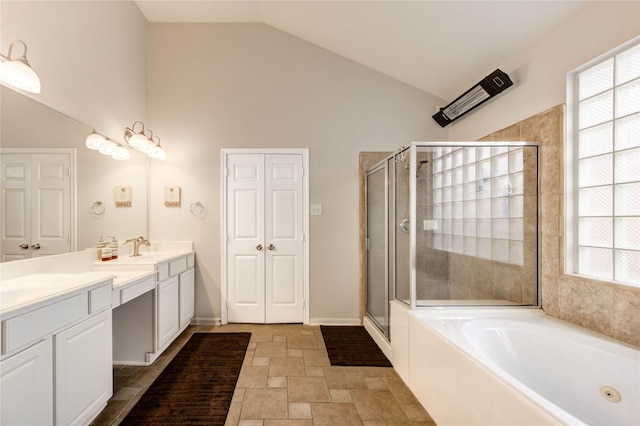 8034 High Hollow Ln, Houston, TX 77070 - bathroom featuring a stall shower, double vanity, a garden tub, stone finish floors, and high vaulted ceiling