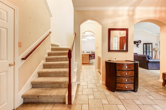 8034 High Hollow Ln, Houston, TX 77070 - staircase featuring arched walkways, crown molding, and stone tile flooring