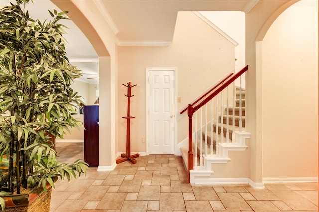 8034 High Hollow Ln, Houston, TX 77070 - entryway with stone tile flooring, stairs, crown molding, and arched walkways