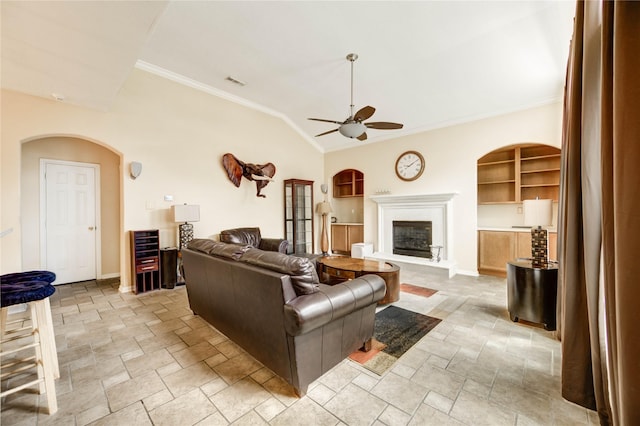 8034 High Hollow Ln, Houston, TX 77070 - living room with a ceiling fan, stone tile floors, arched walkways, a glass covered fireplace, and crown molding