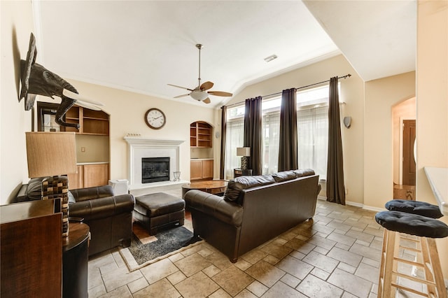 8034 High Hollow Ln, Houston, TX 77070 - living room with arched walkways, a ceiling fan, stone tile floors, and vaulted ceiling