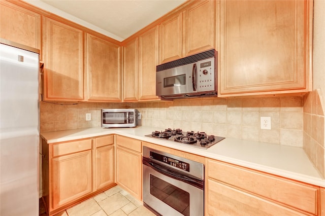 8034 High Hollow Ln, Houston, TX 77070 - kitchen featuring appliances with stainless steel finishes, light brown cabinets, tasteful backsplash, light countertops, and light tile patterned floors