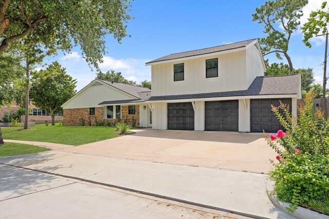 5302 Wigton Dr, Houston, TX 77096 - modern farmhouse featuring driveway, a front lawn, a garage, and roof with shingles