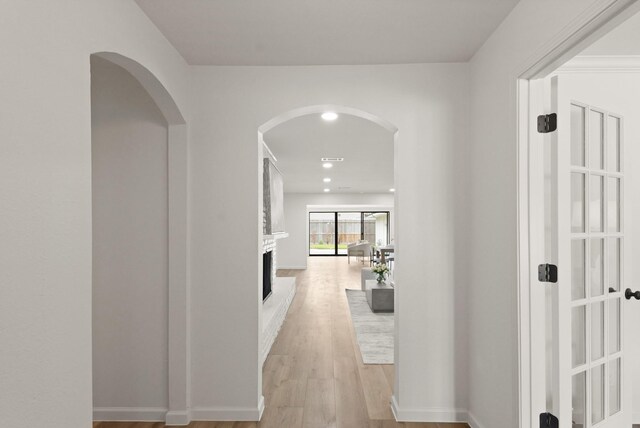 5302 Wigton Dr, Houston, TX 77096 - hall featuring arched walkways and light wood-style floors
