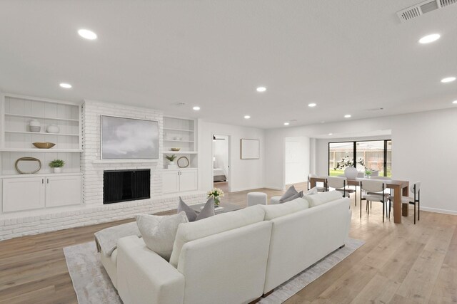 5302 Wigton Dr, Houston, TX 77096 - living area featuring recessed lighting, light wood-style floors, a fireplace, and built in features