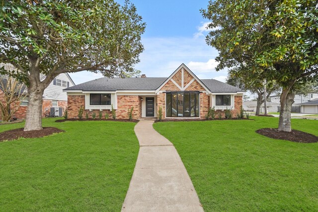 5302 Wigton Dr, Houston, TX 77096 - view of front of home featuring brick siding, a front lawn, and roof with shingles