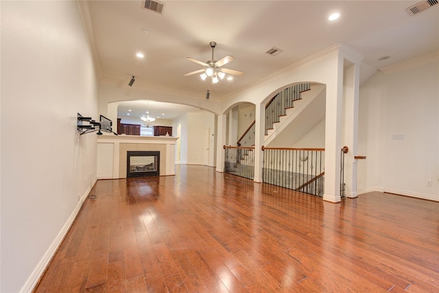 7115 Laguna Villas, Houston, TX 77036 - unfurnished living room with ceiling fan, crown molding, hardwood / wood-style floors, arched walkways, and recessed lighting