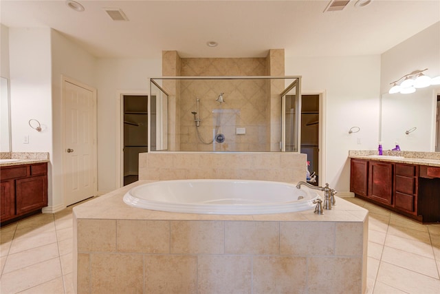 7115 Laguna Villas, Houston, TX 77036 - bathroom with tile patterned flooring, a stall shower, a garden tub, vanity, and a walk in closet