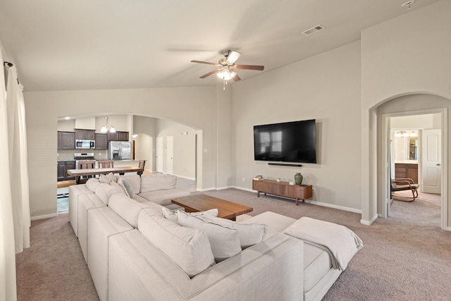 19110 Macallan Ln, Katy, TX 77449 - living room with arched walkways, light colored carpet, ceiling fan, and lofted ceiling