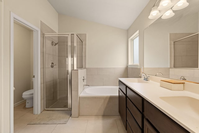 19110 Macallan Ln, Katy, TX 77449 - bathroom with a stall shower, a garden tub, double vanity, vaulted ceiling, and tile patterned flooring