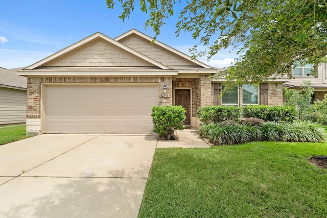 19110 Macallan Ln, Katy, TX 77449 - view of front facade with concrete driveway, brick siding, a front lawn, and a garage