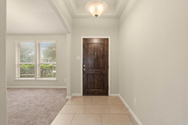 19110 Macallan Ln, Katy, TX 77449 - foyer entrance with light tile patterned floors, light colored carpet, and arched walkways