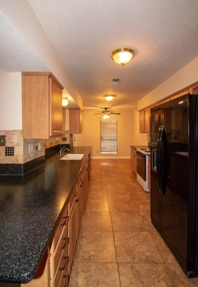 5523 Fair Forest Dr, Houston, TX 77088 - kitchen with black fridge with ice dispenser, electric range oven, dark countertops, ceiling fan, and light tile patterned floors