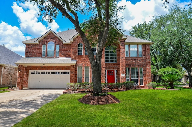 16210 S Temple Dr, Houston, TX 77095 - view of front facade with driveway, an attached garage, a front yard, brick siding, and a shingled roof