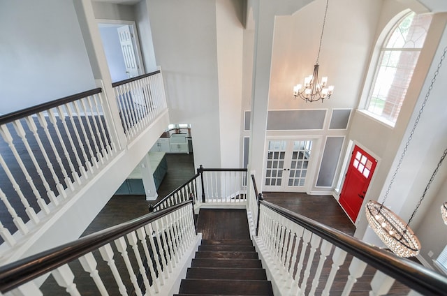 16210 S Temple Dr, Houston, TX 77095 - staircase featuring a high ceiling, a chandelier, wood finished floors, and french doors