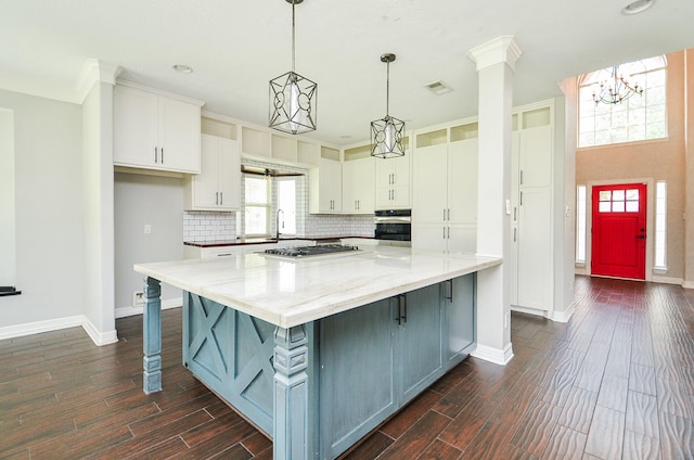 16210 S Temple Dr, Houston, TX 77095 - kitchen featuring appliances with stainless steel finishes, white cabinetry, dark wood-style floors, a large island, and crown molding