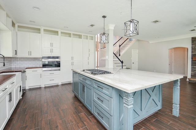 16210 S Temple Dr, Houston, TX 77095 - kitchen with stainless steel appliances, gray cabinets, backsplash, white cabinetry, and ornamental molding