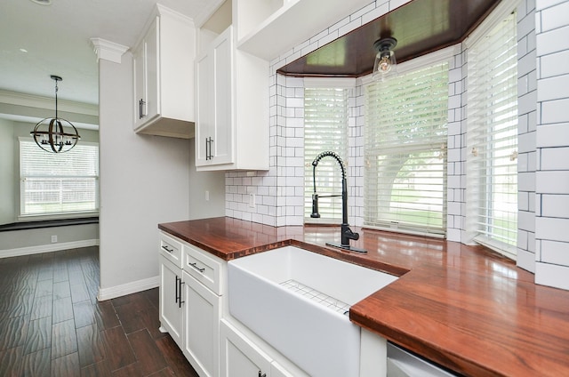 16210 S Temple Dr, Houston, TX 77095 - kitchen featuring butcher block countertops, a chandelier, tasteful backsplash, white cabinets, and decorative light fixtures