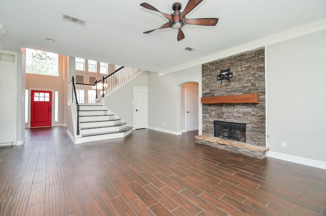 16210 S Temple Dr, Houston, TX 77095 - unfurnished living room featuring a ceiling fan, a chandelier, a fireplace, stairway, and arched walkways