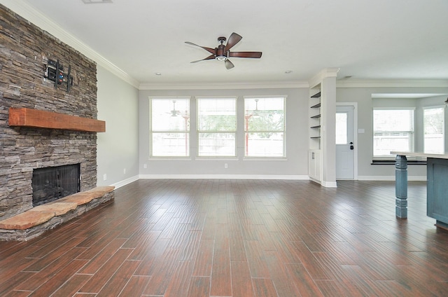 16210 S Temple Dr, Houston, TX 77095 - unfurnished living room with ceiling fan, a stone fireplace, crown molding, and dark wood-style flooring