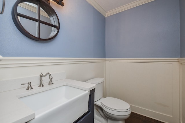 16210 S Temple Dr, Houston, TX 77095 - bathroom featuring ornamental molding, vanity, wainscoting, wood finished floors, and a decorative wall