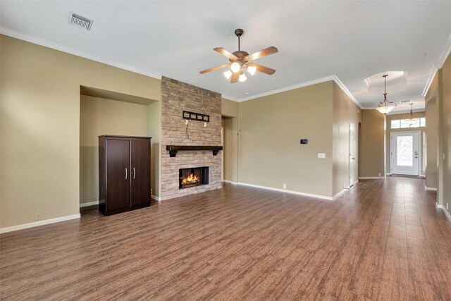 1431 Hidden Terrace Dr, Sugar Land, TX 77479 - unfurnished living room with a ceiling fan, dark wood-style flooring, ornamental molding, and a stone fireplace