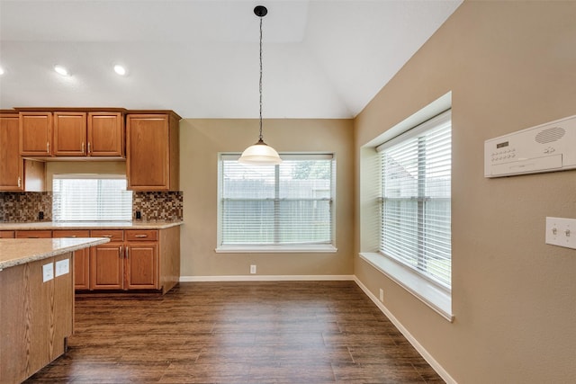 1431 Hidden Terrace Dr, Sugar Land, TX 77479 - kitchen featuring lofted ceiling, decorative backsplash, hanging light fixtures, dark wood-style flooring, and brown cabinets