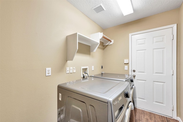 1431 Hidden Terrace Dr, Sugar Land, TX 77479 - laundry area with separate washer and dryer, dark wood-type flooring, and a textured ceiling