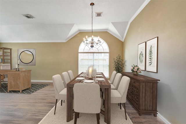 1431 Hidden Terrace Dr, Sugar Land, TX 77479 - dining space with wood finished floors, lofted ceiling, a chandelier, and crown molding